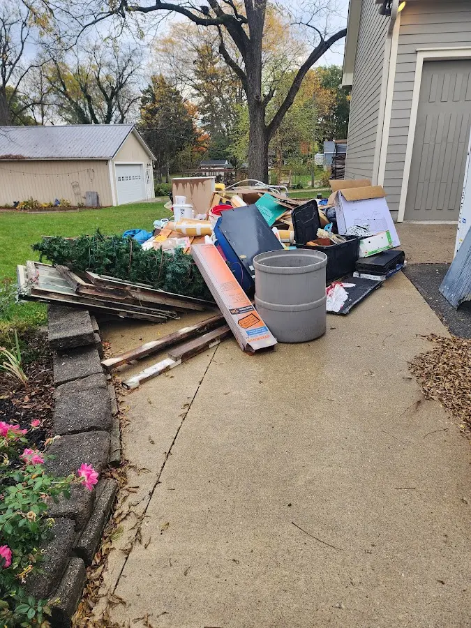 Dumpster being loaded with debris for Estate Cleanout Dumpster Rental in Starkey